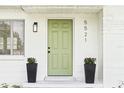 Close-up showcasing the home's front door, planters, and address with a fresh, inviting entrance at 5521 Makoma Dr, Orlando, FL 32839