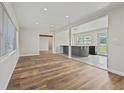 Open concept living space with hardwood flooring and ample natural light, ideal for modern living at 5521 Makoma Dr, Orlando, FL 32839