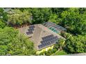 Aerial view of house featuring a screened-in pool and solar panels on the roof for energy efficiency at 6092 Sabal Hammock Cir, Port Orange, FL 32128