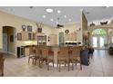 Spacious kitchen with a central island, seating, stainless steel appliances, and a walk-in pantry at 6092 Sabal Hammock Cir, Port Orange, FL 32128