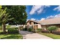 Attractive home featuring stone accents, a well-manicured lawn, and a driveway at 6226 Wynfield Court, Orlando, FL 32819