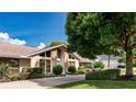 Well-maintained home featuring a stone facade, manicured landscaping, and a long driveway at 6226 Wynfield Court, Orlando, FL 32819