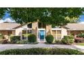 Inviting front entrance with a modern blue door, complemented by manicured landscaping and stone accents at 6226 Wynfield Court, Orlando, FL 32819