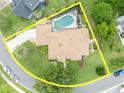 Aerial view of a private residence showcasing a swimming pool, well-maintained lawn and a circular driveway at 6630 Hidden Beach Cir, Orlando, FL 32819
