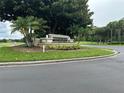 Bermuda Dunes community sign surrounded by lush green landscaping at 7230 Westpointe Blvd # 1235, Orlando, FL 32835