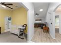 Open-concept home featuring a living room with wood flooring and a view into a room with bright yellow walls at 7764 Indian Ridge N Trl, Kissimmee, FL 34747