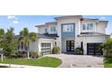 Beautiful modern two-story home featuring a black metal roof, a paved driveway, and a two-car garage at 9156 Sheen Sound St, Orlando, FL 32836