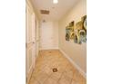 A well-lit hallway features tile flooring and modern artwork at 101 S Eola Dr # 1021, Orlando, FL 32801