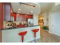 A modern kitchen with dark wood cabinets, stainless appliances, and barstool seating at 101 S Eola Dr # 1021, Orlando, FL 32801