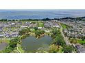 Breathtaking aerial view showcasing the community's lush landscape, lake, pool and the beautiful waterfront at 102 Hammock Preserve Loop, Winter Garden, FL 34787