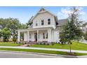Charming two-story home boasting a welcoming front porch and meticulously maintained landscaping adding to its allure at 102 Hammock Preserve Loop, Winter Garden, FL 34787