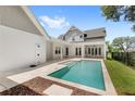 Private backyard pool featuring a sun deck and a covered patio ideal for outdoor entertaining and relaxation at 102 Hammock Preserve Loop, Winter Garden, FL 34787