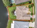 Aerial view of home showcasing the lot, screened-in patio, and proximity to the lake at 106 Winghurst Blvd, Orlando, FL 32828