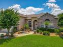 Charming single-Gathering home with manicured lawn and beautiful landscaping at 106 Winghurst Blvd, Orlando, FL 32828