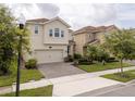 Beautiful two-story home with a paved driveway and lush landscaping at 1097 Trappers Trail Loop, Davenport, FL 33896