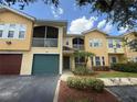Inviting two-story condo with a screened balcony and a well-maintained landscaped front yard at 12016 Villanova Dr # 102, Orlando, FL 32837