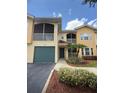 Charming condo featuring a one-car garage, screened-in balcony, and nicely landscaped surroundings at 12016 Villanova Dr # 102, Orlando, FL 32837