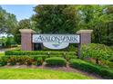 Elegant Avalon Park entrance sign surrounded by vibrant greenery and manicured landscaping at 13028 Auburn Cove Ln, Orlando, FL 32828