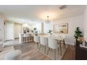Open-concept dining area adjacent to the kitchen, complete with modern lighting and stylish decor at 13028 Auburn Cove Ln, Orlando, FL 32828