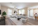 Bright living room featuring a plush white sectional, modern decor, and lots of natural light at 13028 Auburn Cove Ln, Orlando, FL 32828