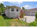 This home shows well-manicured lawn and garden with a three-car garage at 1542 Wescott Loop, Winter Springs, FL 32708