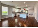 Bright eat-in kitchen featuring white cabinets, stainless appliances, and a center island at 1546 Water Elm Ct, Orlando, FL 32825