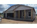 Exterior view of the house under construction, showcasing block walls and roof framing at 1635 Cane Bamboo Drive, St Cloud, FL 34771