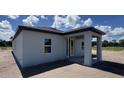 Rear exterior of home with a covered porch area showcasing ample outdoor living space at 1635 Cane Bamboo Drive, St Cloud, FL 34771