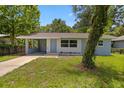 Inviting exterior view of a single-story home with a well-maintained lawn and blue accents at 167 S Sheridan Ave, Deland, FL 32720