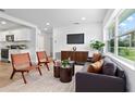 Bright living room featuring modern furniture, hardwood floors, and large windows at 167 S Sheridan Ave, Deland, FL 32720