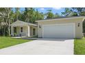 Front exterior showcasing the home's architectural style and well-manicured yard at 17 Cypress Run, Haines City, FL 33844