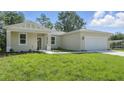Well-maintained house showcasing lush lawn, neutral exterior, and inviting entryway at 17 Cypress Run, Haines City, FL 33844
