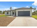 Charming single-story home featuring a spacious two-car garage and a large front yard at 17315 Sw 26Th Terrace Rd, Ocala, FL 34473