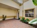 Paver patio with potted plants, covered ceiling, and natural lighting at 17322 Chateau Pine Way, Clermont, FL 34711