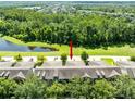 Aerial view of townhome with pond and nature views at 2021 Sweet Birch Ln, Orlando, FL 32828