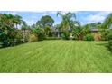 The well-manicured lawn features a fountain and lush tropical landscaping at this brick-accented home at 209 7Th S St, Haines City, FL 33844