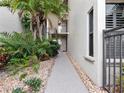 Walkway to building entrance with tropical landscaping, and building exterior at 2121 Hill St # 7B, New Smyrna Beach, FL 32169