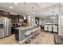 Modern kitchen with stainless steel appliances, granite countertops, and breakfast bar seating at 2121 Morocco Way, Kissimmee, FL 34747