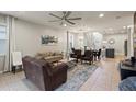 Open-concept living room with tile floors, comfortable seating, and lots of natural light at 2121 Morocco Way, Kissimmee, FL 34747