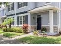 Inviting home entrance with well-maintained landscaping, stone accents and a covered front porch at 2211 J Lawson Blvd, Orlando, FL 32824