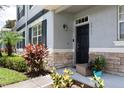Inviting front entrance with well-kept landscaping, stone accents, and covered front porch at 2211 J Lawson Blvd, Orlando, FL 32824