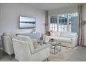 Bright living room with a large window, modern furniture, and a neutral color palette at 2380 Celebration Blvd, Celebration, FL 34747