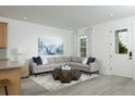 Modern living room with gray sectional sofa and natural light at 2386 Celebration Blvd, Celebration, FL 34747