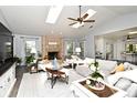 Bright living room with brick fireplace, vaulted ceiling, and abundant natural light at 26 Canter Club Ct, Debary, FL 32713