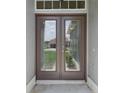 Close-up of the home's double front doors with glass inserts, offering a welcoming entrance at 3326 Sassaquin Ct, Orlando, FL 32818