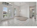 Bright, airy living room with tile and wood flooring, large windows, and high ceilings at 3326 Sassaquin Ct, Orlando, FL 32818