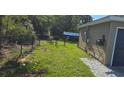 Backyard featuring a well-maintained lawn and secure black chain-link fence at 35 Olive Cir, Ocala, FL 34472