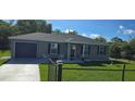 Inviting single-Gathering home with a manicured front yard, fenced perimeter and attached garage at 35 Olive Cir, Ocala, FL 34472