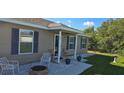 Close-up of the front porch, showcasing stylish outdoor seating and decorative plants at 35 Olive Cir, Ocala, FL 34472