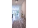 Stylish entryway with tile flooring, a console table, and a view into the dining area at 561 Andrea S Cir, Haines City, FL 33844